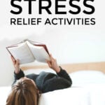 Woman lying on bed reading a book