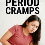 Young woman holding her stomach in pain