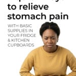 Young woman holding her stomach with pain