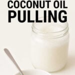 Jar of coconut oil with some scooped out.