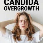 Young woman wearing a white t-shirt holding her head