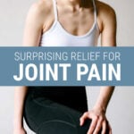 Young woman holding her knee with joint pain