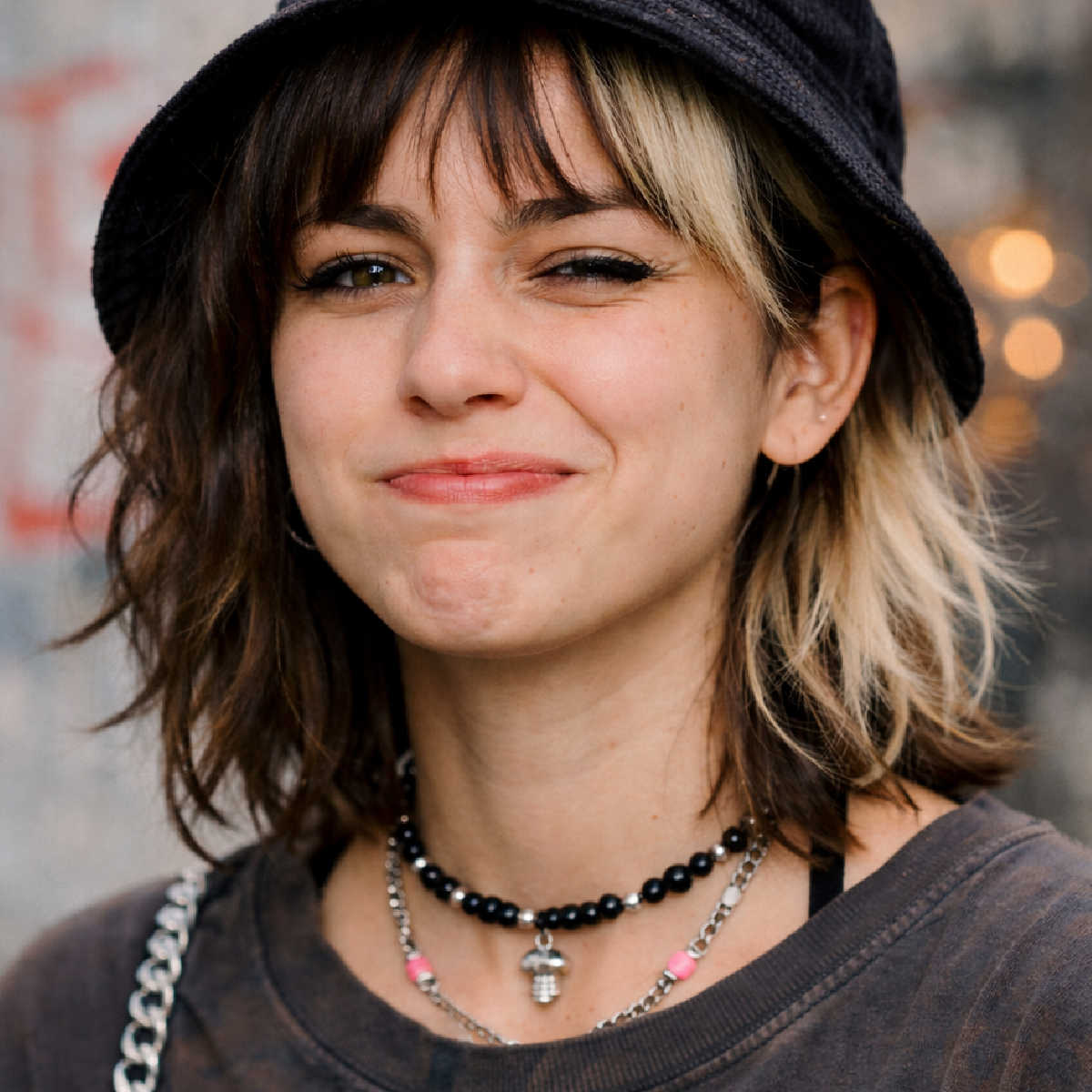 Young woman smiling but grimacing slightly