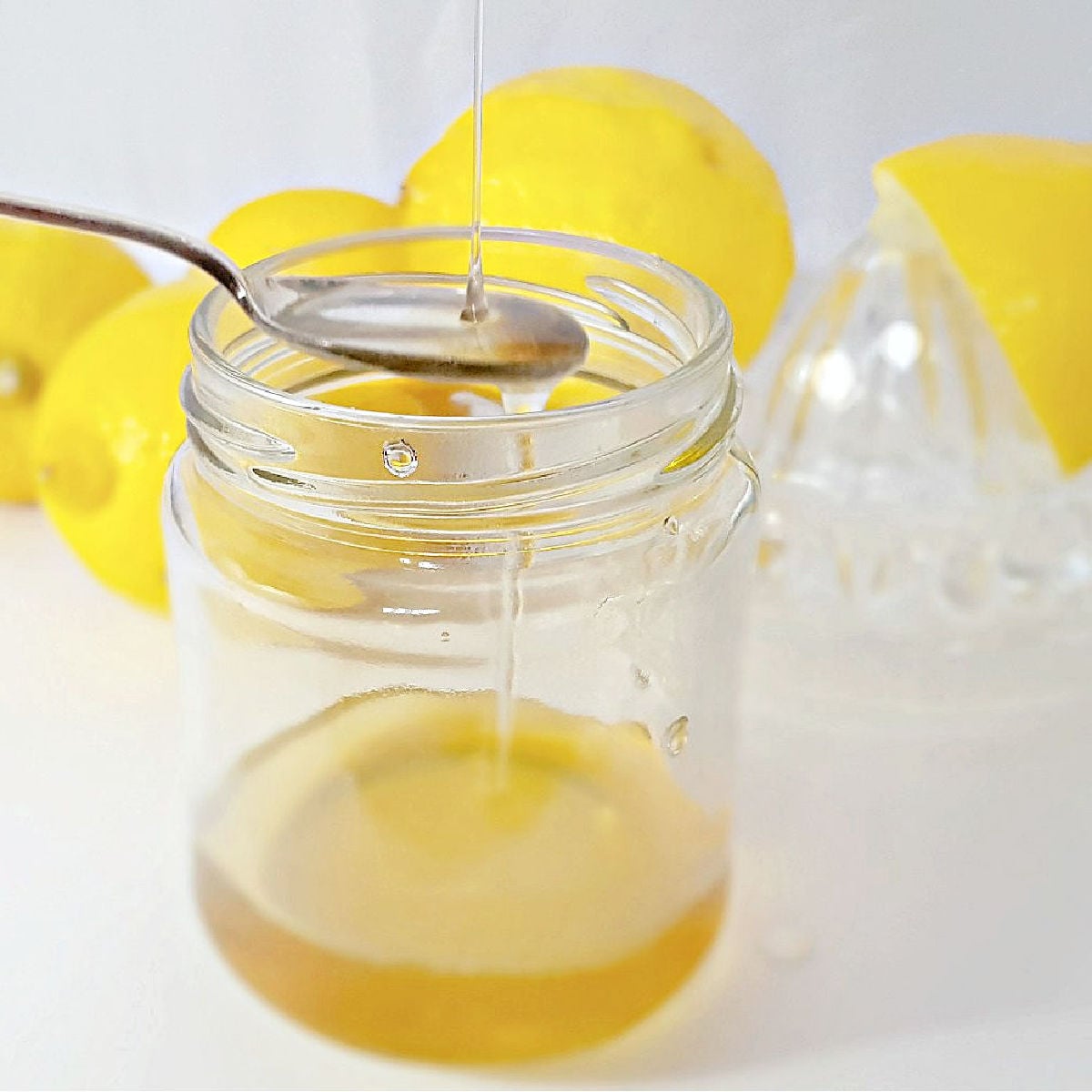 Honey drizzled into a jar of lemon juice