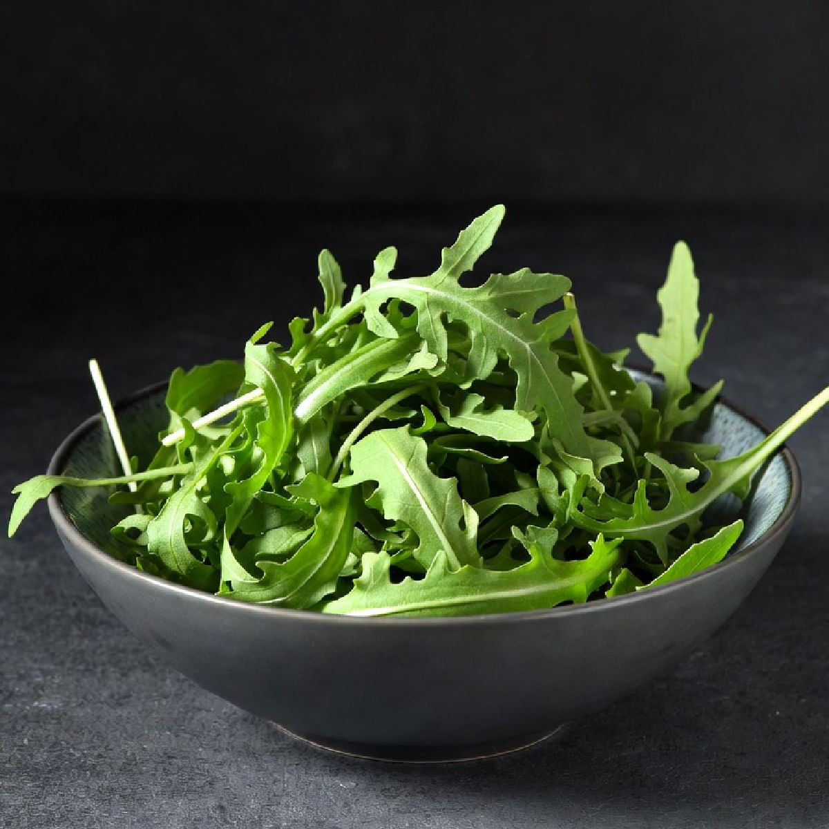 A bowl of arugula (rocket) leaves
