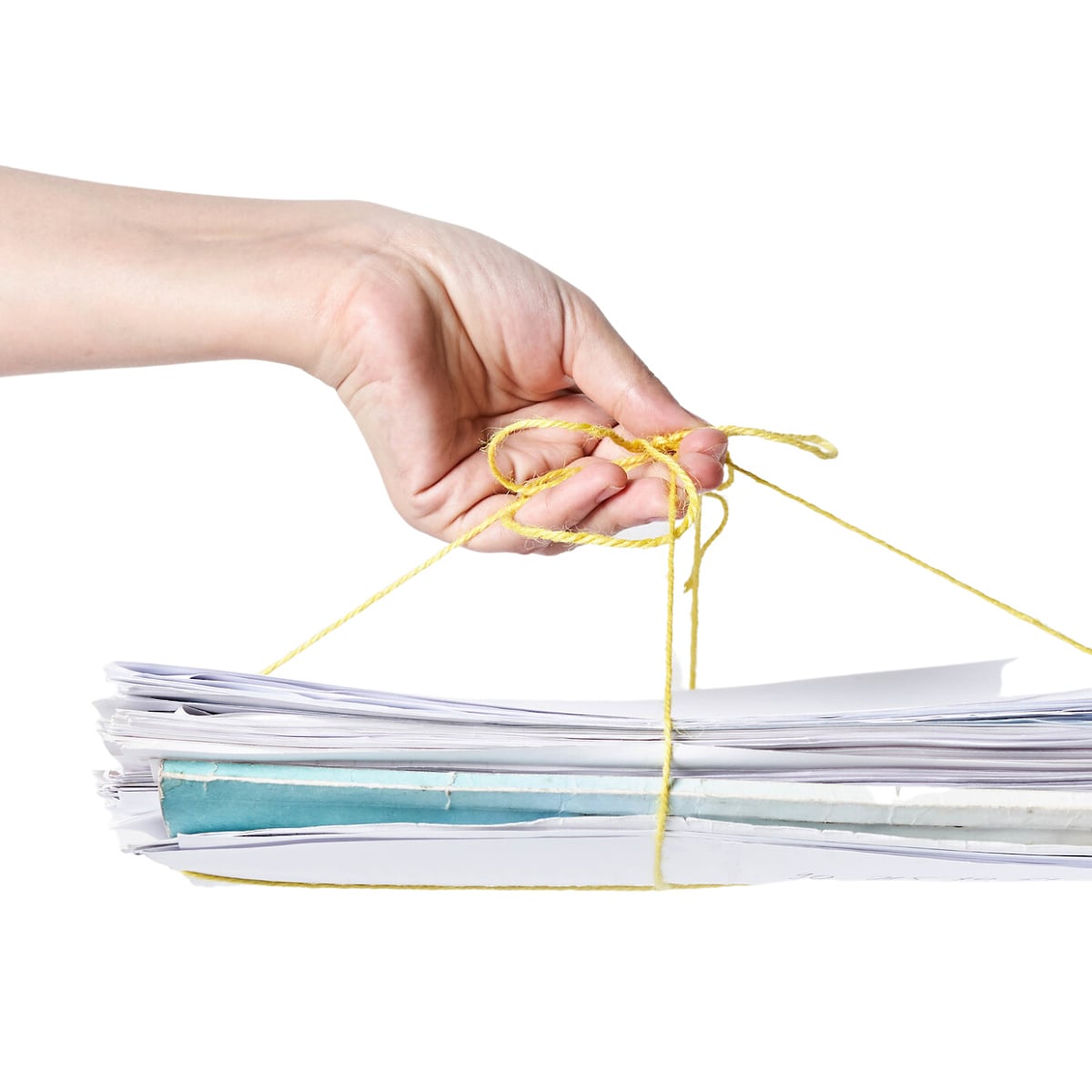 Woman holding pile of paper tied together with string