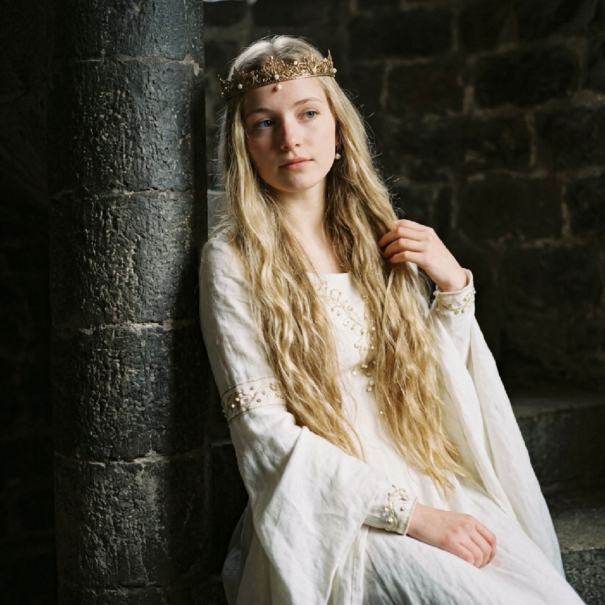 Medieval style princess leaning against castle wall