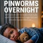 Young boy cuddling teddybear in bed